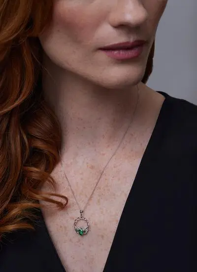 Close up of red haired model wearing Sterling Silver Green Stone Claddagh Pendant